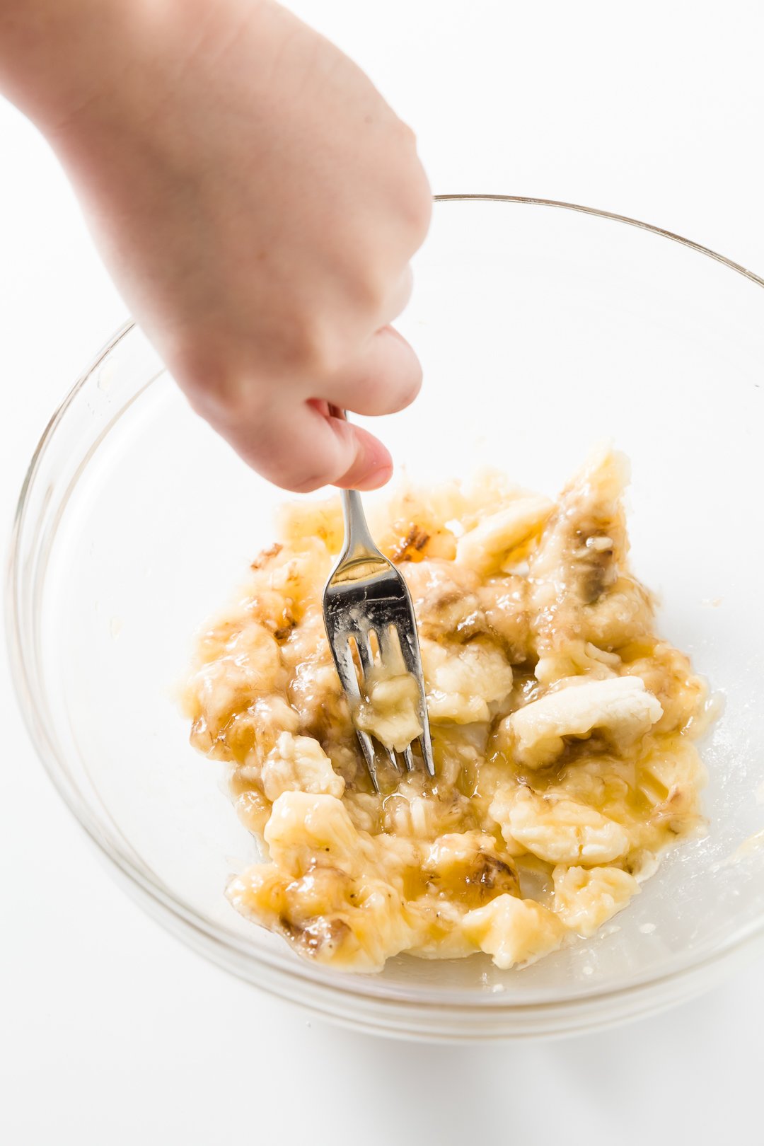 Mashing a banana with a fork