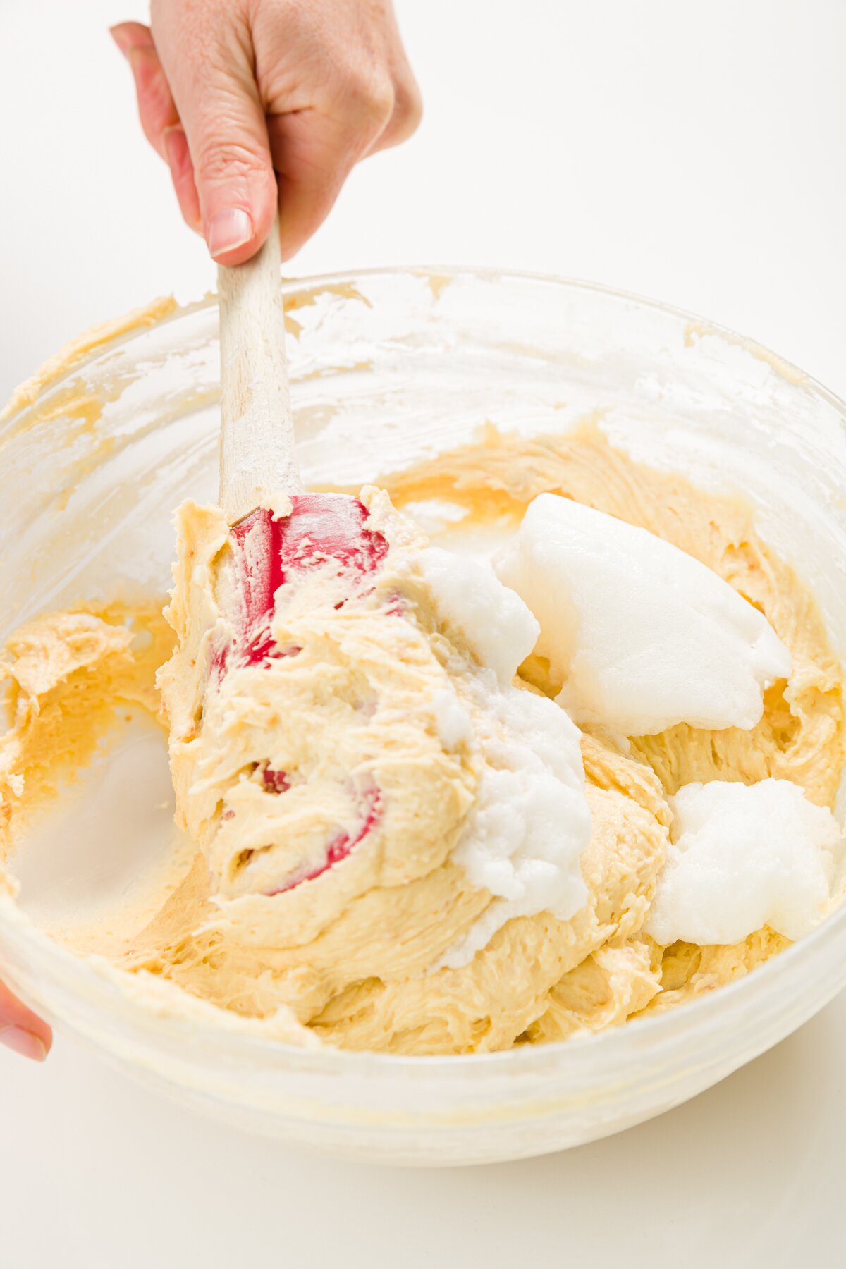 Folding in egg whites to batter in a glass bowl
