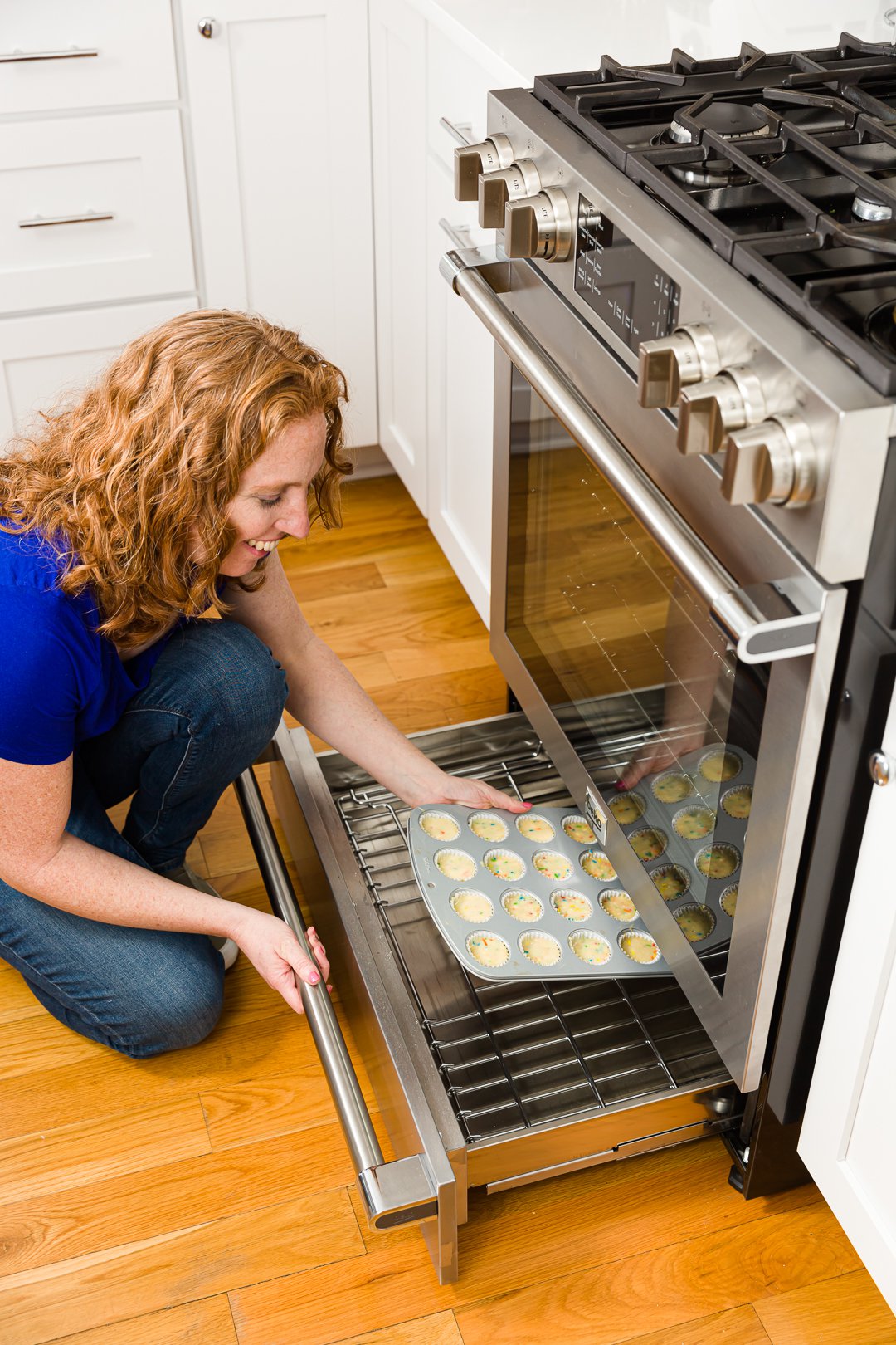 Loading cupcakes into the oven