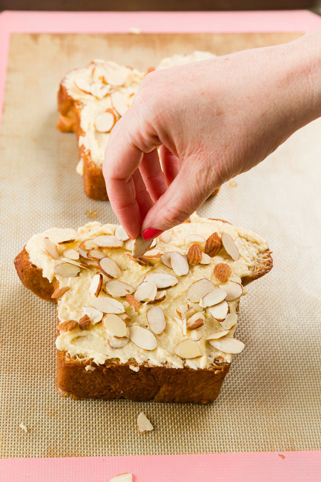 Sprinkling almonds on bostock