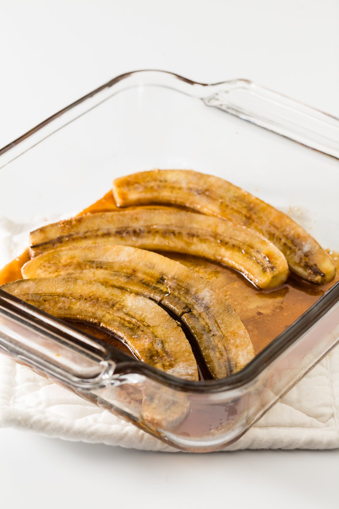oven baked caramelized bananas in a glass baking dish