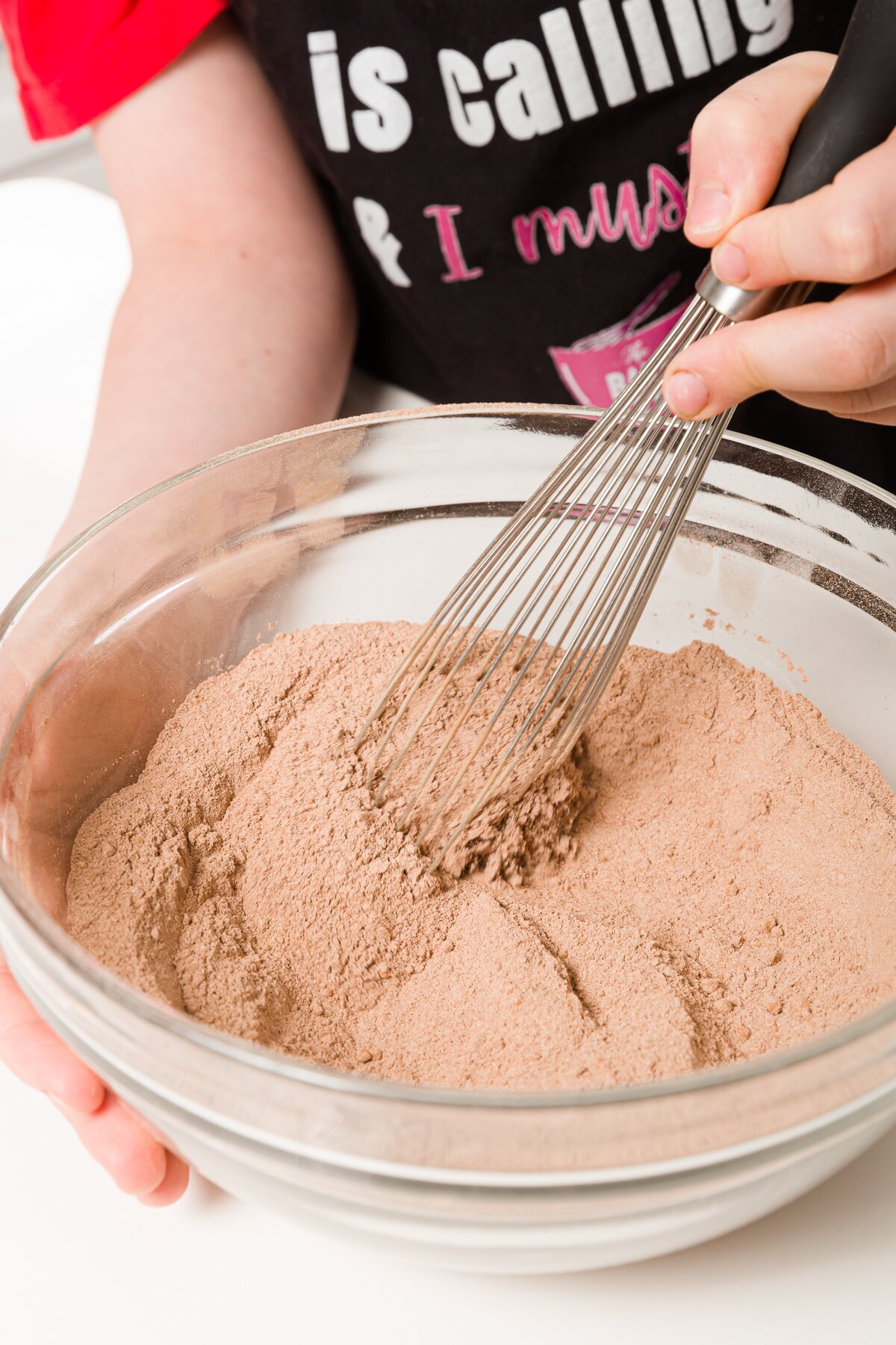 Whisking together dry ingredients in a glass bowl
