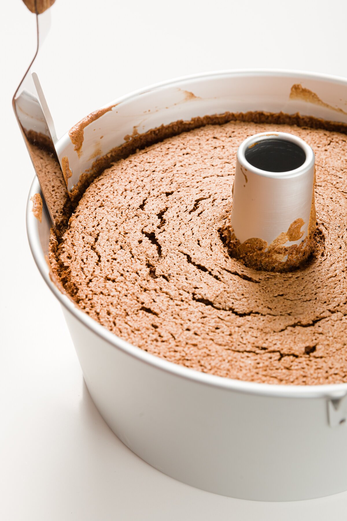 Using an offset spatula to remove cake from pan