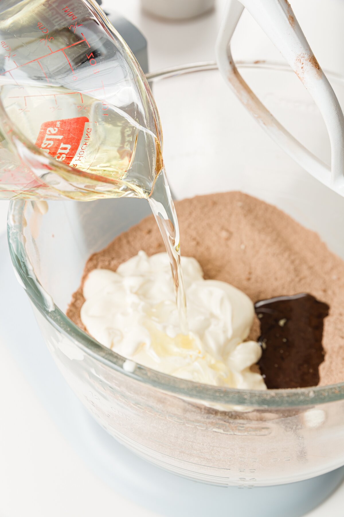 Pouring vegetable oil into stand mixer 