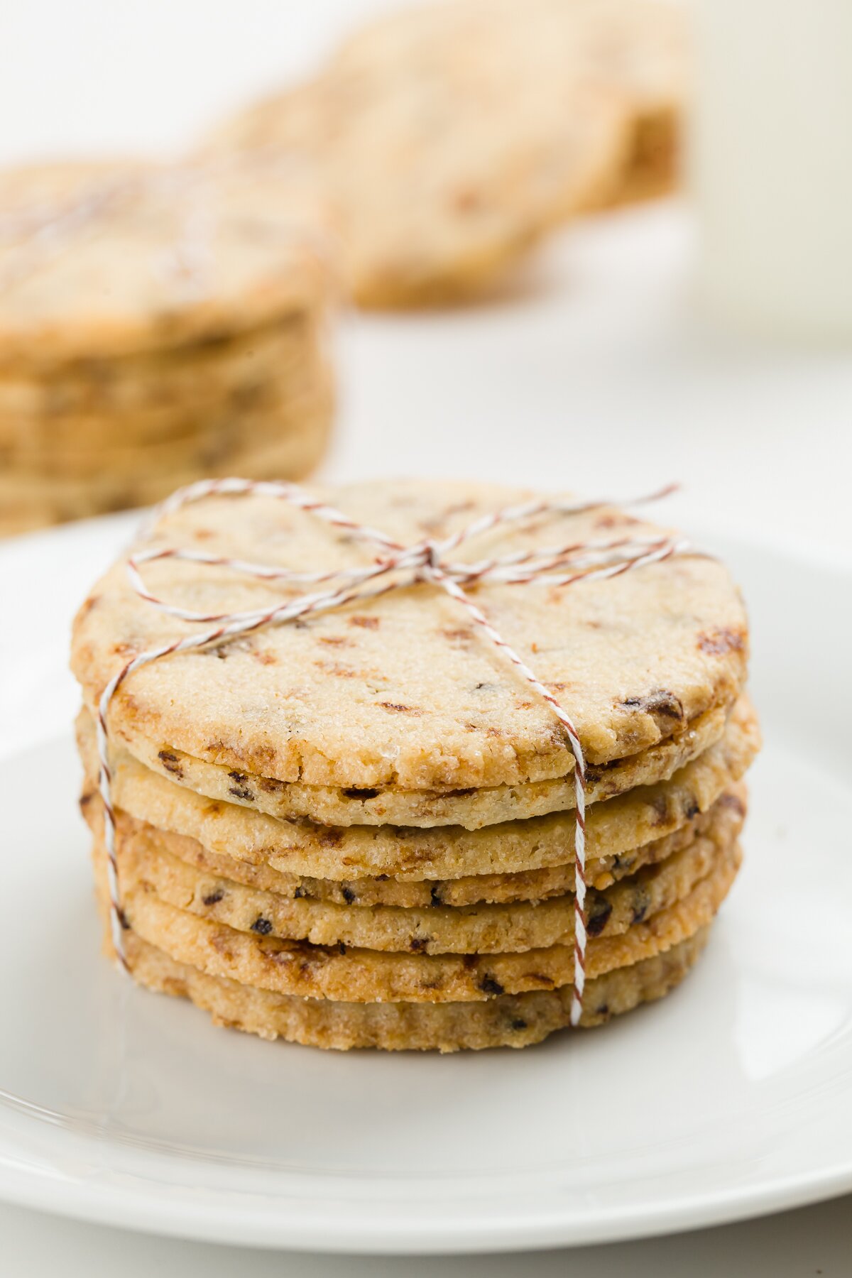 Stack of coffee cookies wrapped in bakers twine with other stacks in the background