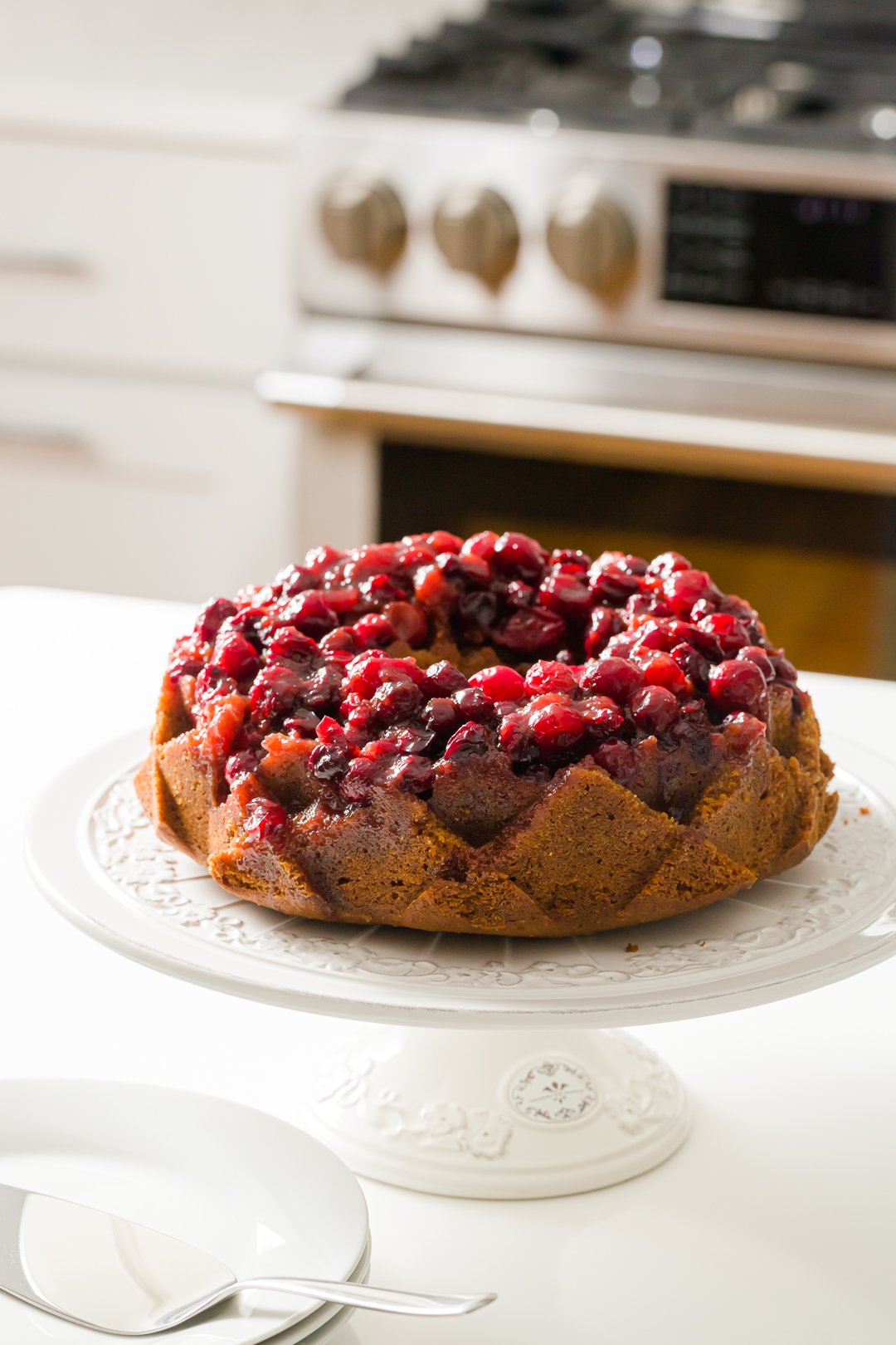 cranberry cake on a cake stand on the counter