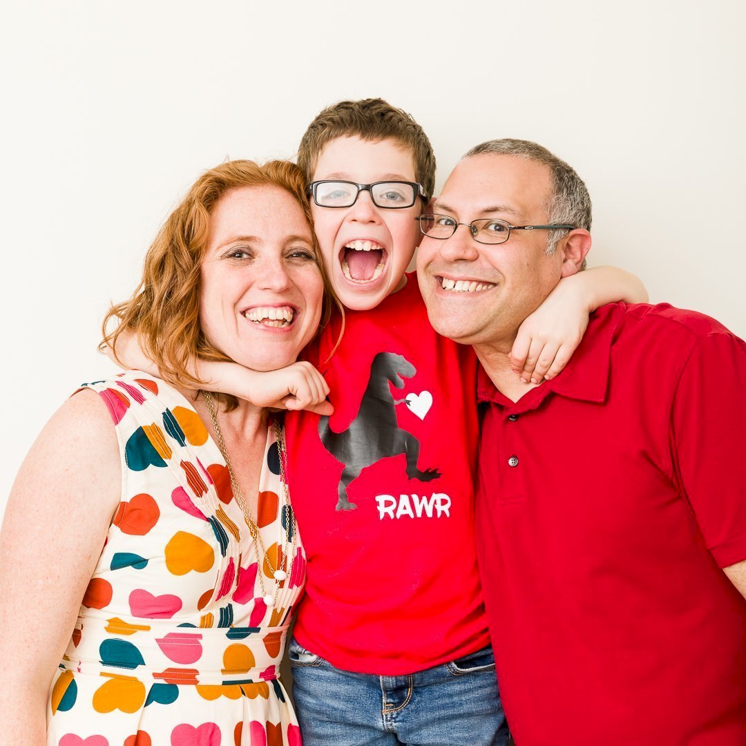 A photo of Stefani Pollack, Jonathan Pollack, and Myles Pollack with arms around each other