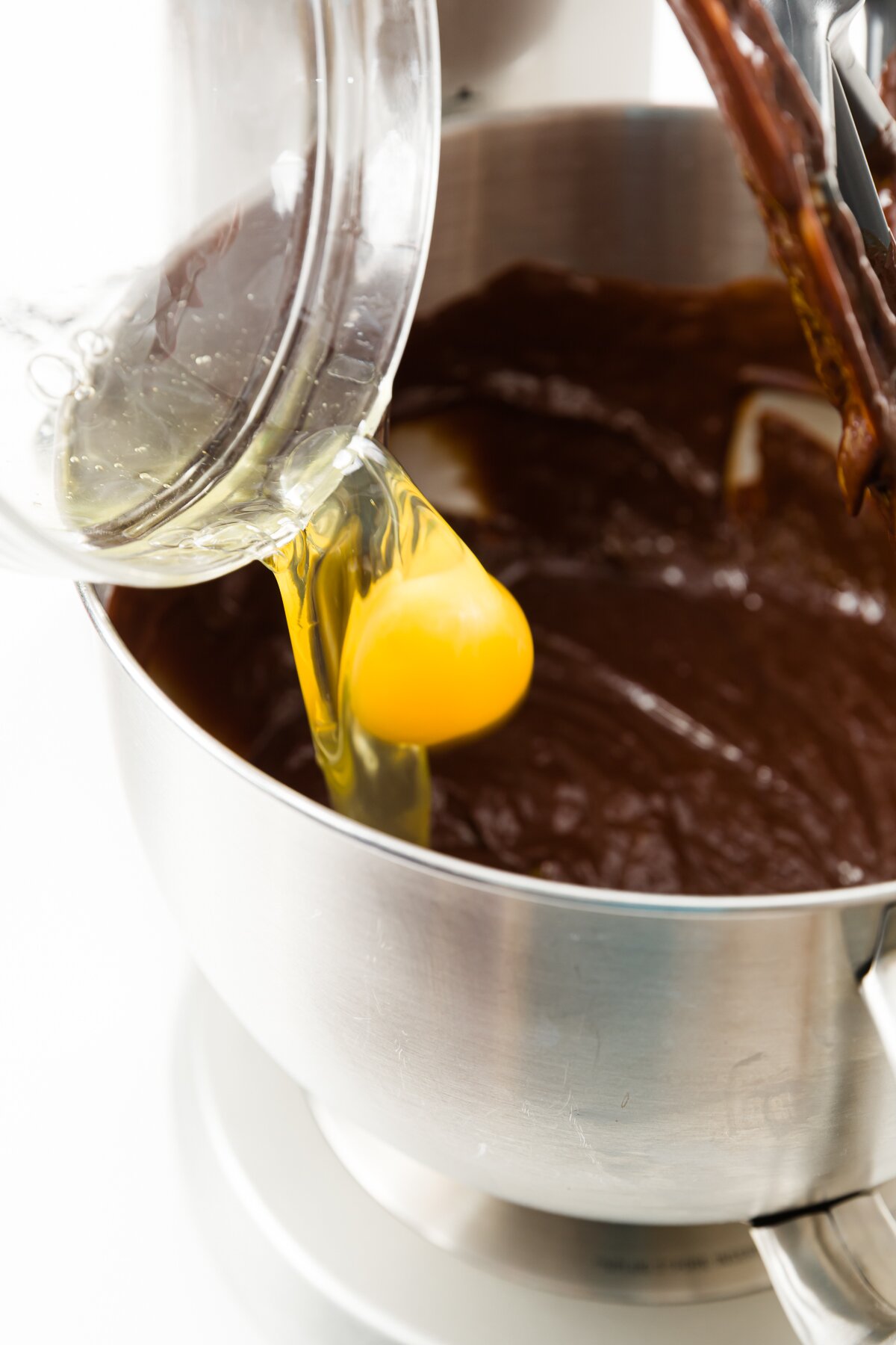 Egg being dropped into stand mixer