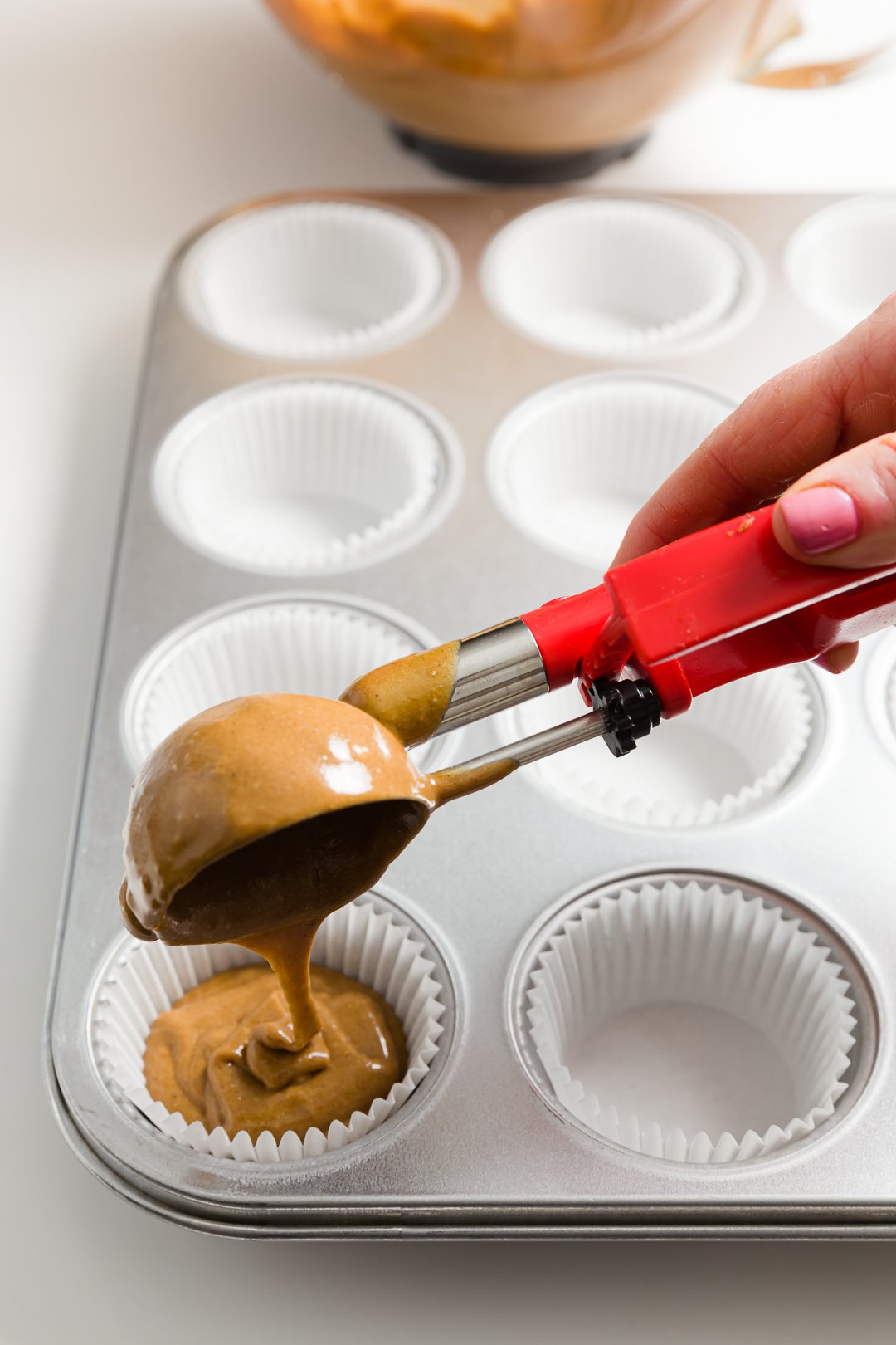 Filling cupcake liners with an ice cream scoop