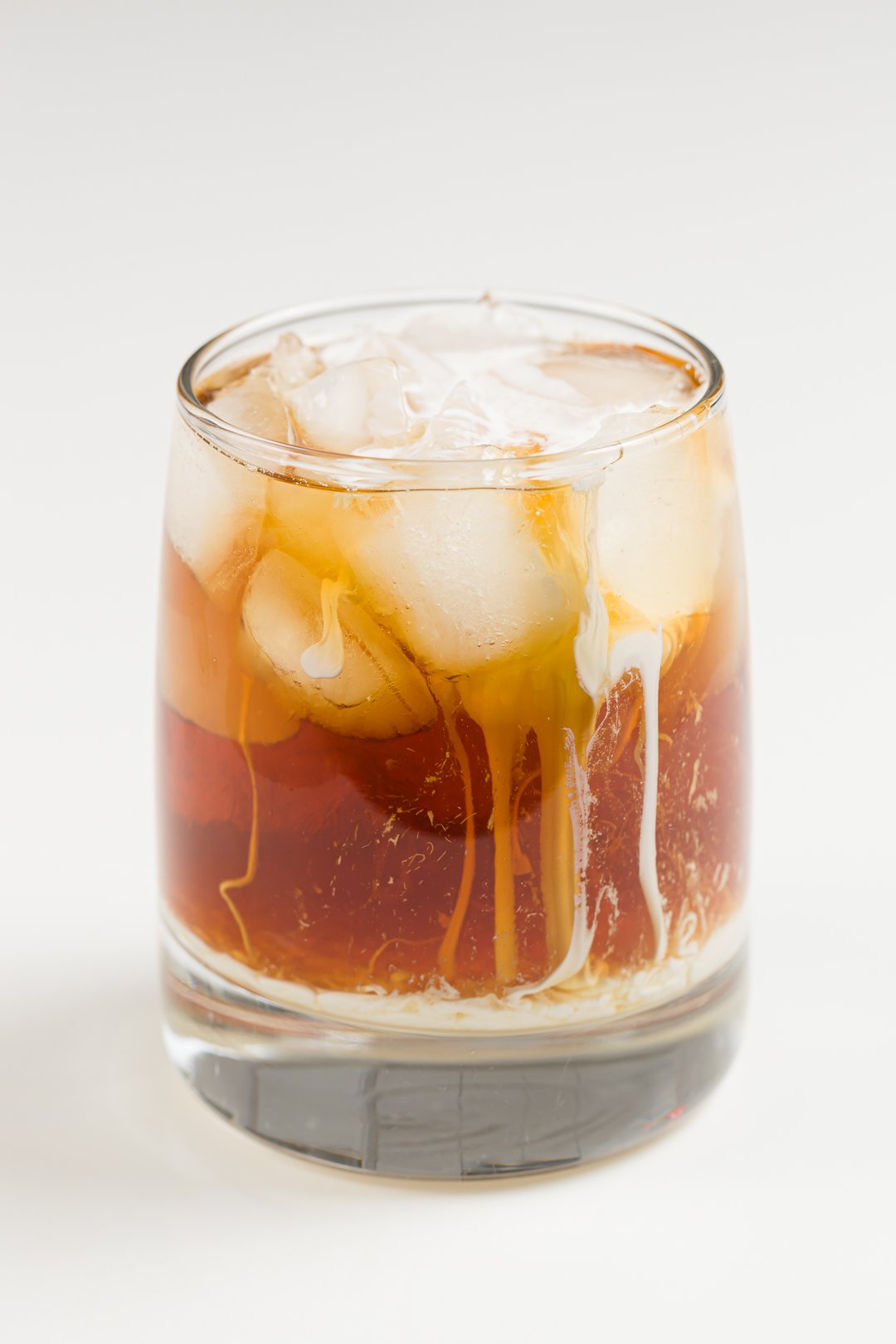 glass with a White Russian cocktail made with homemade Kahlua