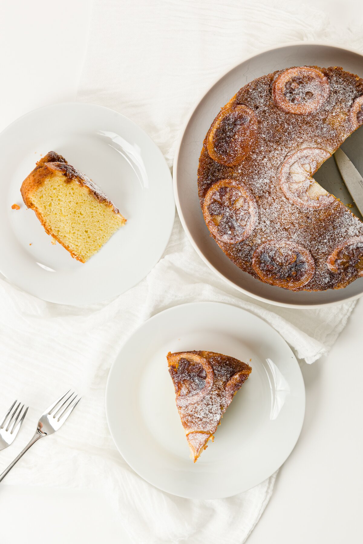 Overhead shot of cake and two plates of cake