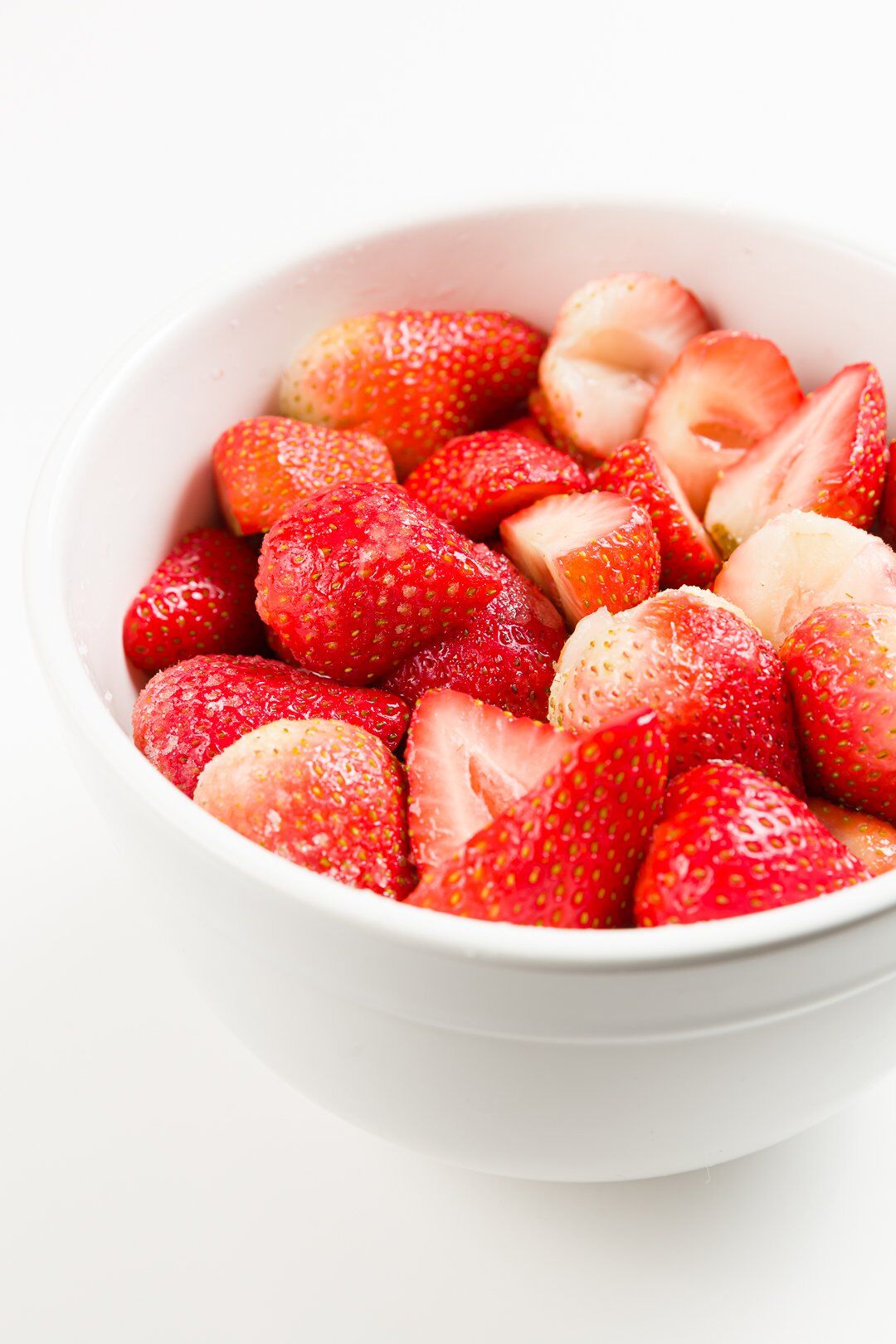 A large bowl of strawberries macerated for one hour in sugar
