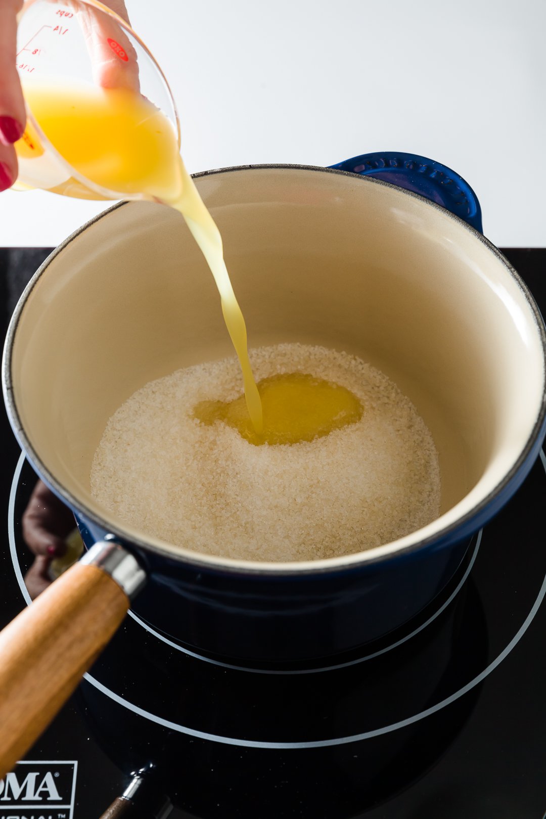 Orange juice and sugar in a pot