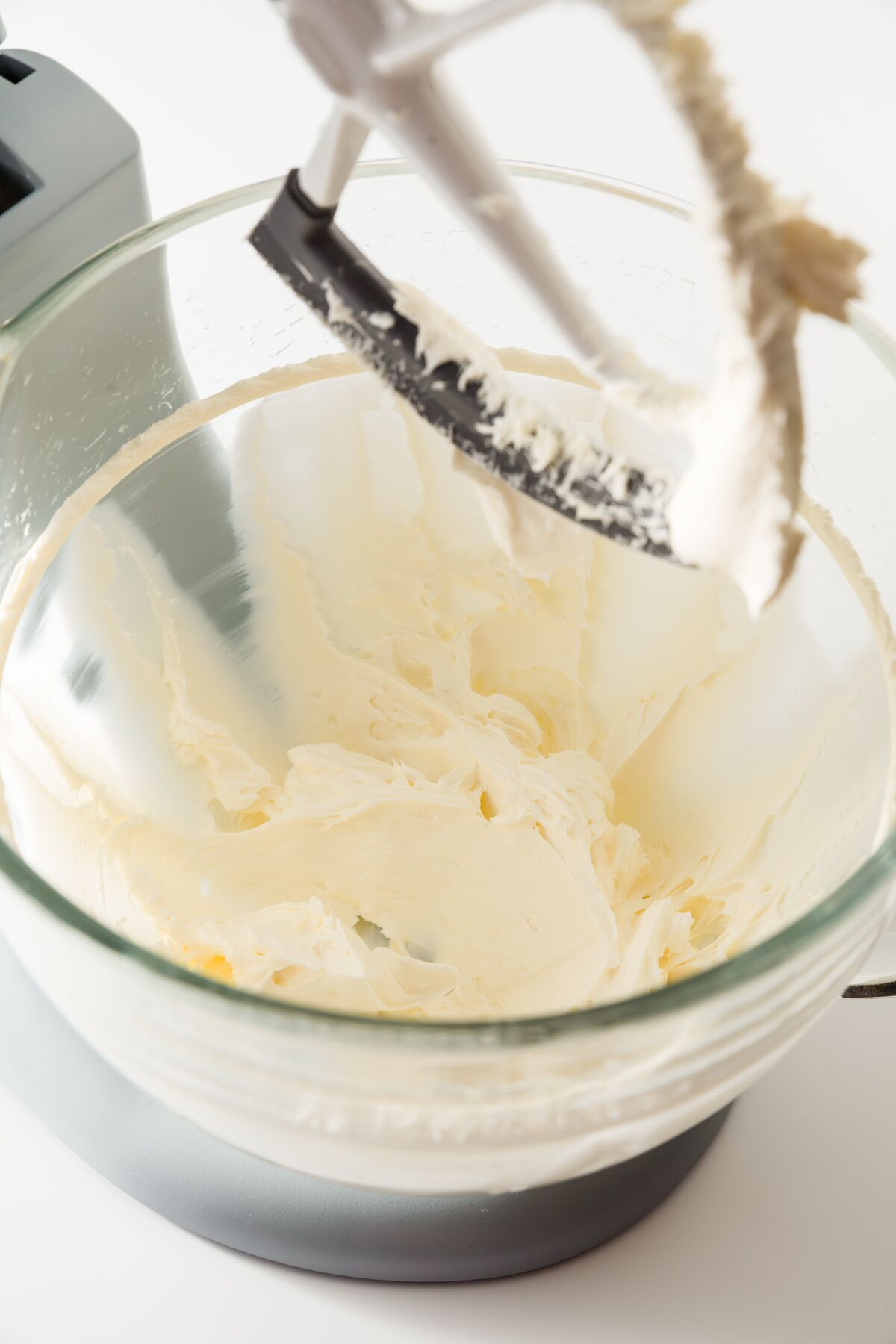 Aerated butter and cream cheese in a glass mixing bowl