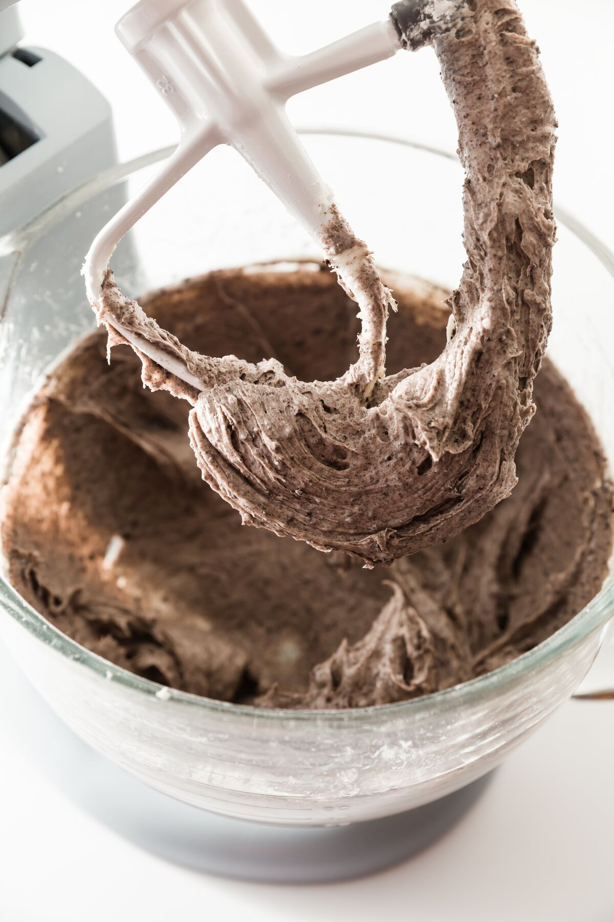 Oreo cookies and cream frosting on a mixer paddle