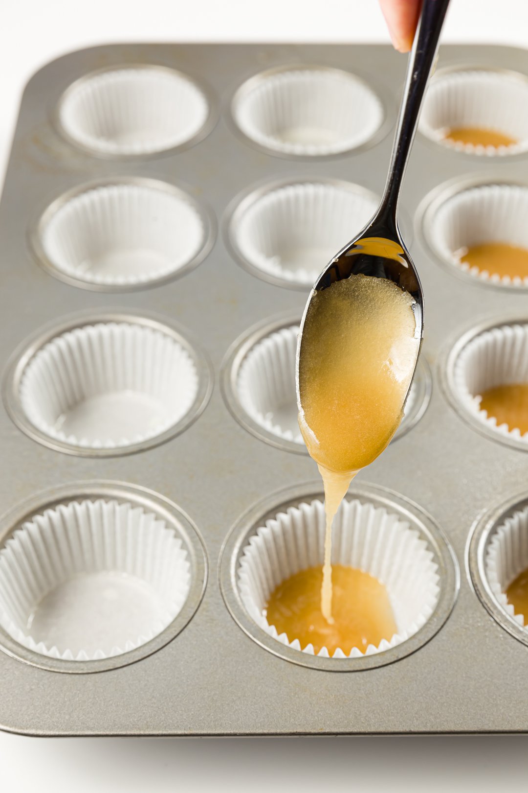 Adding caramel to cupcake liners