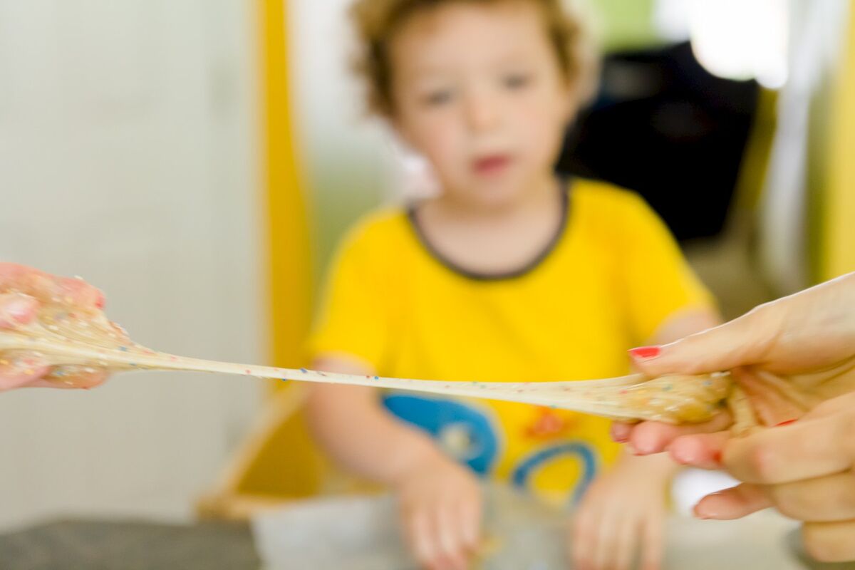 Salt water taffy being pulled with a little kid watching