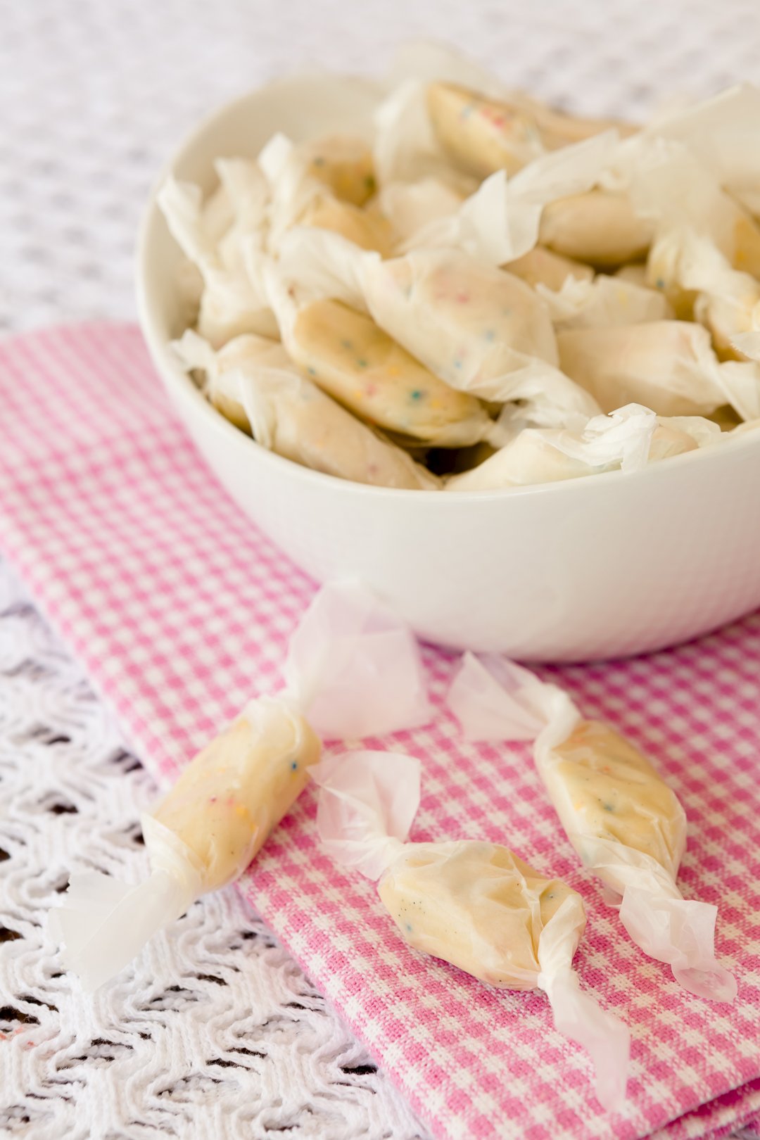 Salt Water Taffty in a white bowl on a checkered cloth