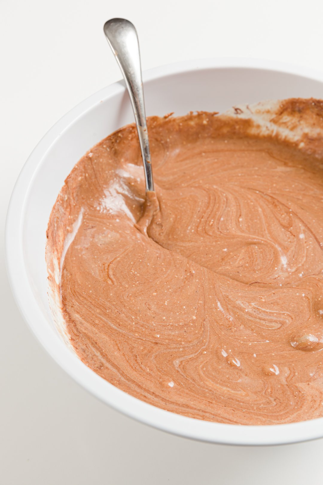 looking into a bowl full of chocolate cheesecake batter