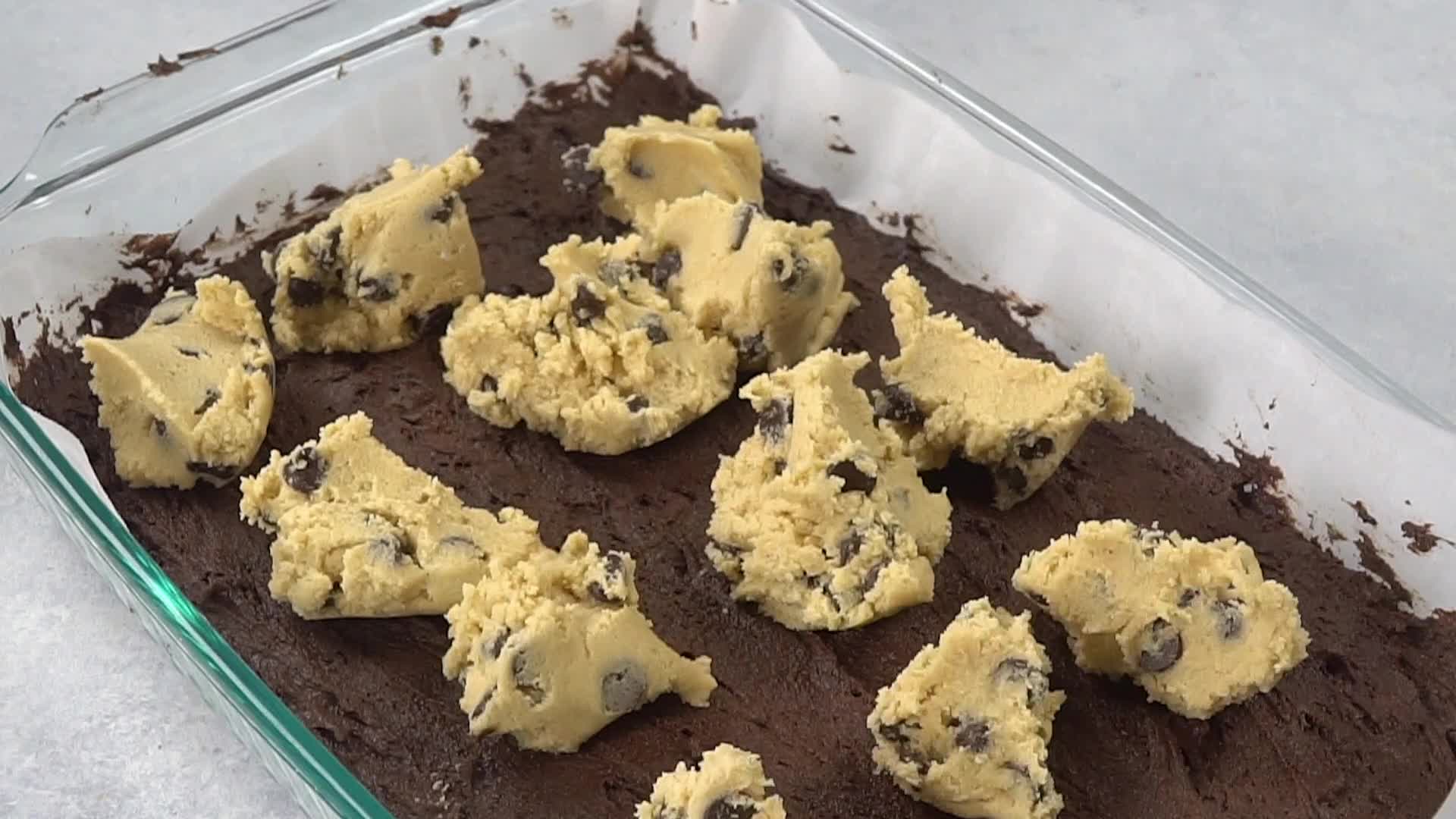 Chocolate chip cookie batter over brownie batter